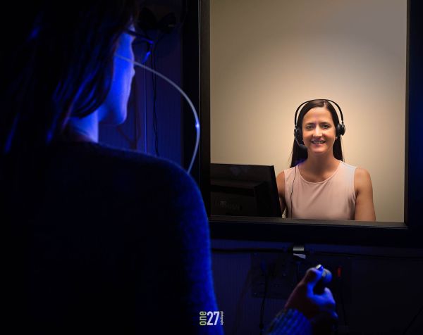 audiologist performing hearing test